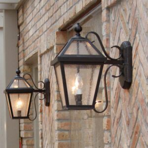 London EX-5708-A13 brass outdoor wall lanterns mounted on a brick exterior