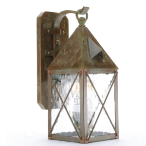 Lancaster wall lantern with a scrolled hook, pitched roof, and Crosscut overlay over clear glass, shown against a white background.